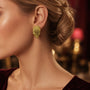 Model wearing gold-plated sterling silver textured leaf earrings