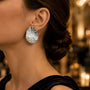 Model wearing silver-tone hammered freshwater pearl statement stud earrings