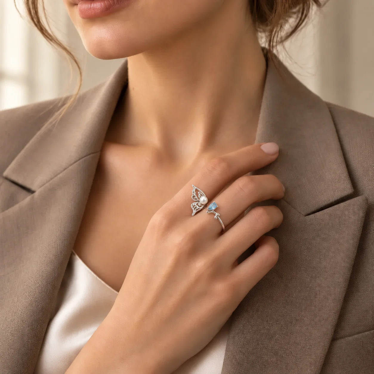 Woman wearing an adjustable sterling silver butterfly ring with freshwater pearl