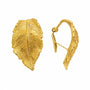 Close-up of engraved leaf veins and curved gold-plated sterling silver earring