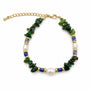 Green gemstone blue ceramic and baroque pearl bracelet on a white background
