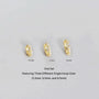 Three gold hoop earrings of different sizes on a gray background