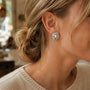 Model wearing silver-tone hammered organic freshwater pearl stud earrings