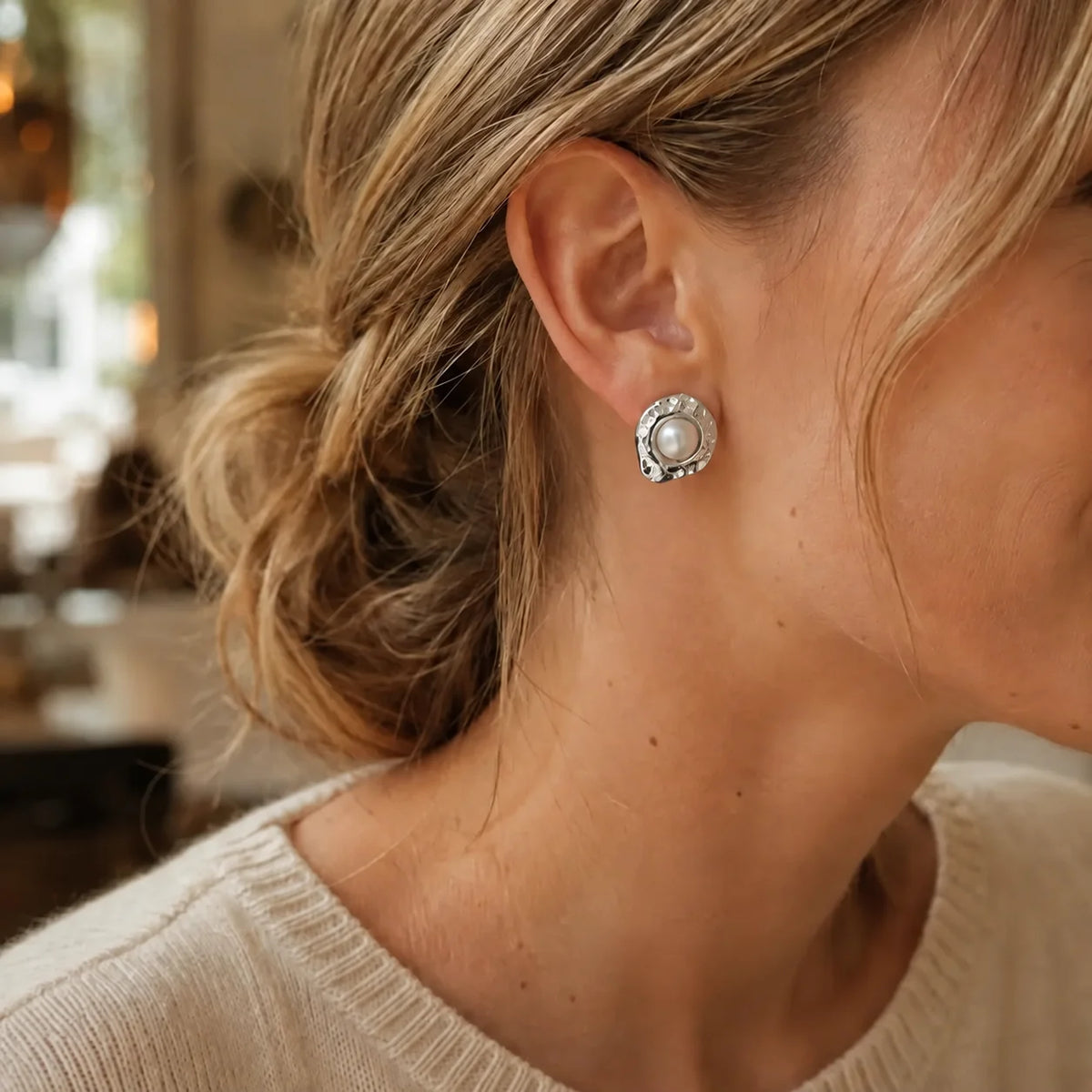 Model wearing silver-tone hammered organic freshwater pearl stud earrings