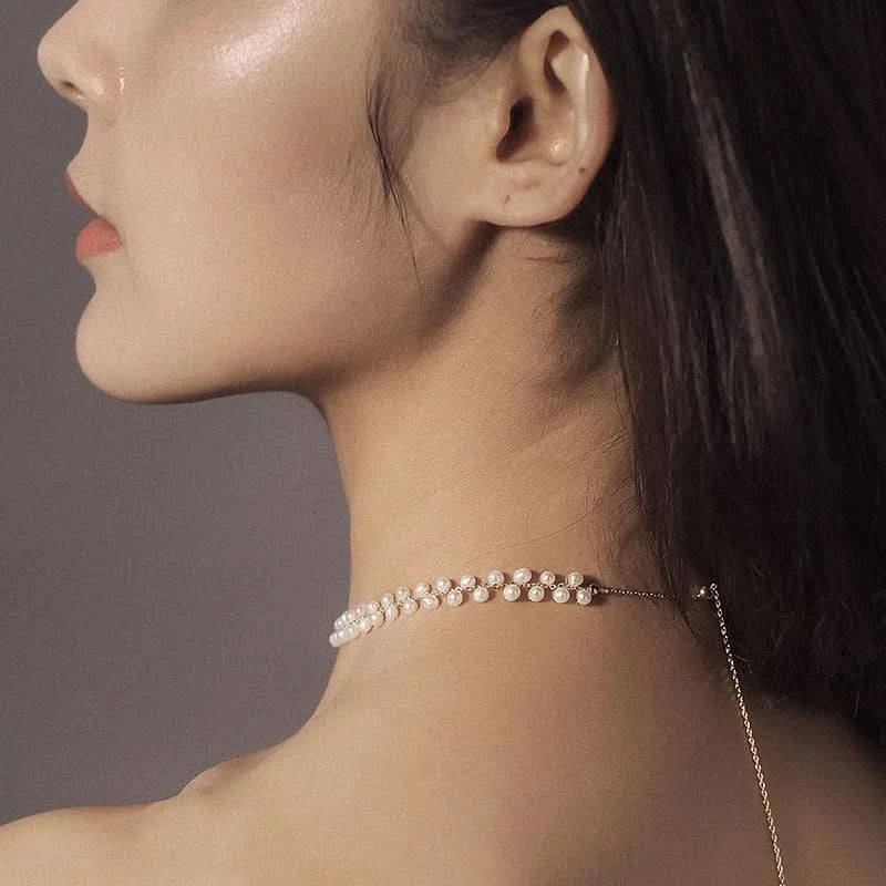 Close-up of a woman wearing a delicate pearl necklace 