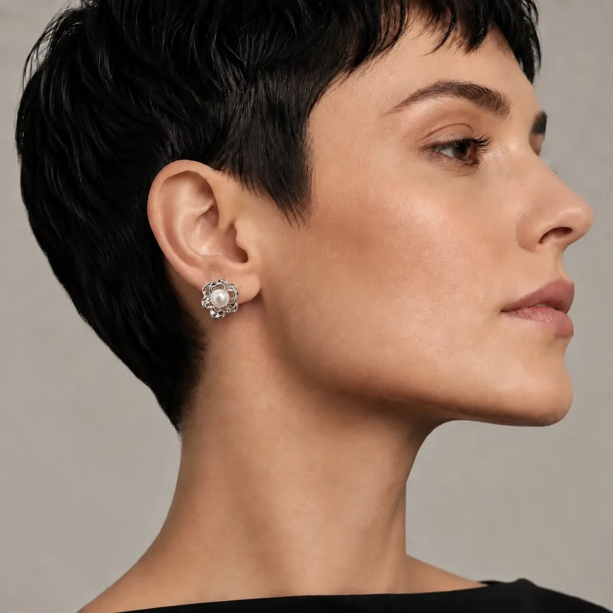 Model wearing silver-tone freshwater pearl sculpted flower stud earrings