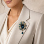 Deep Ocean Blue crystal cluster drop brooch worn on a light blazer