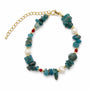 Blue apatite and freshwater pearl gemstone bracelet on a white background