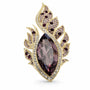 Gold tone purple flame leaf crystal brooch on a white background