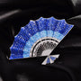 Blue crystal fan brooch displayed on black silk