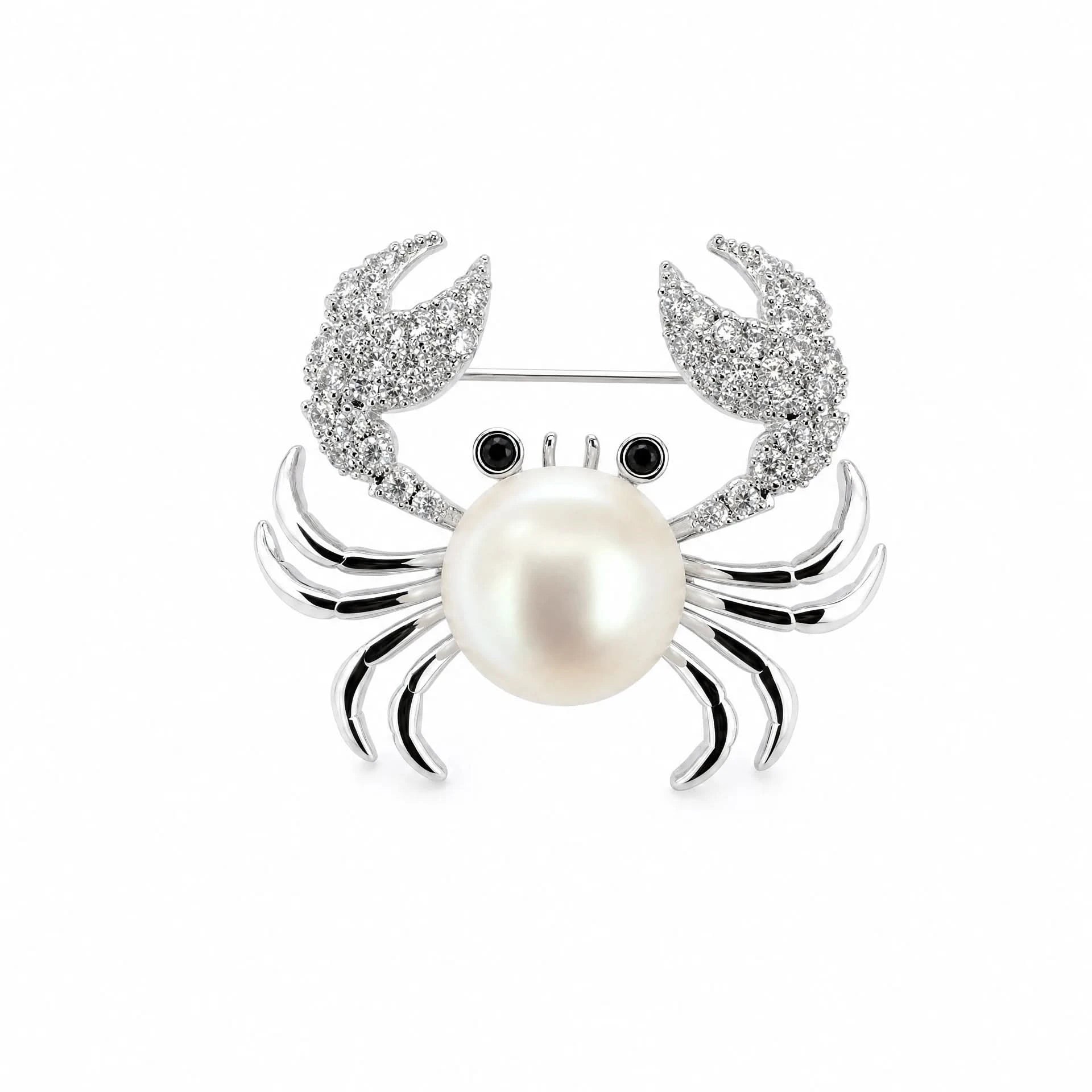 Silver-tone pearl crab brooch with cubic zirconia claws and black eyes on a white background