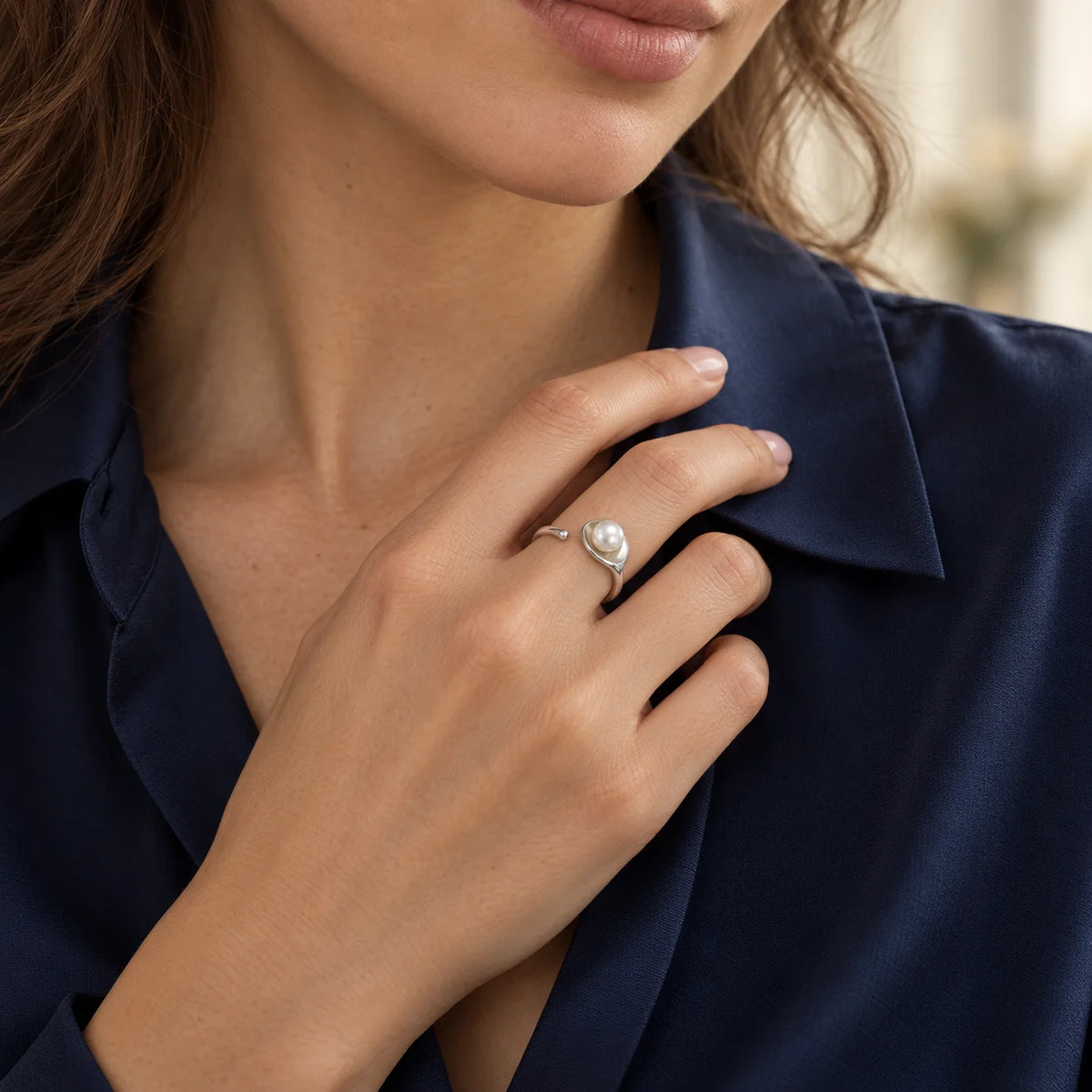 Woman wearing an adjustable sterling silver freshwater pearl leaf ring