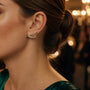 Model wearing gold-plated sterling silver feather pearl ear climber earrings