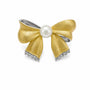 Two-tone brushed bow brooch with freshwater pearl and cubic zirconia details on a white background