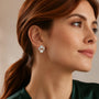 Model wearing gold-tone freshwater pearl floral cluster stud earrings with clear zircon petals