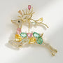 Front view of multicolour crystal reindeer brooch with pink green blue and yellow stones