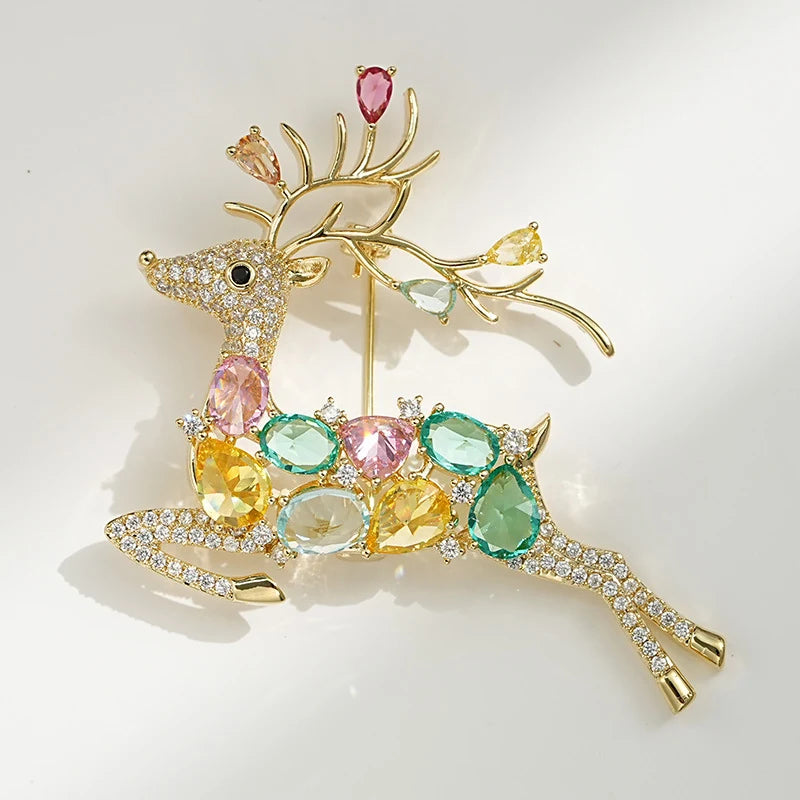 Front view of multicolour crystal reindeer brooch with pink green blue and yellow stones