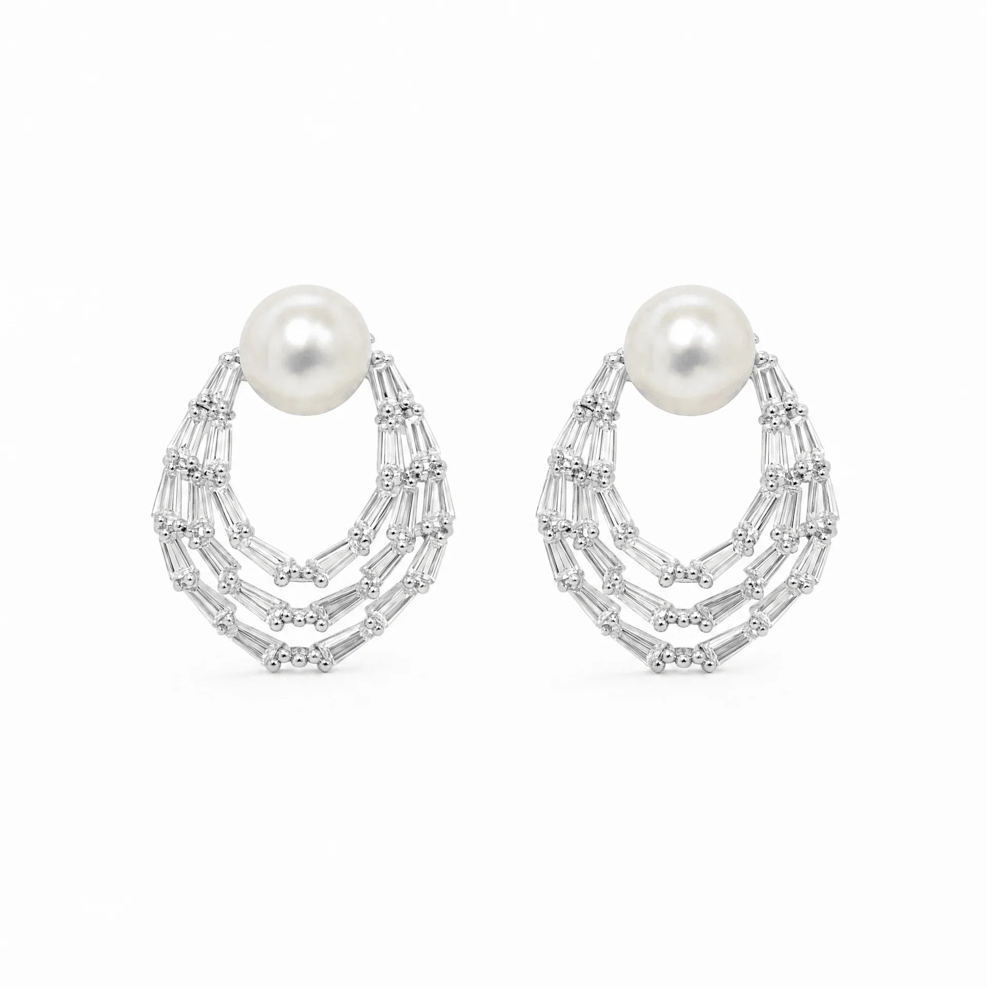Silver-tone freshwater pearl stud earrings with layered baguette crystal teardrops
