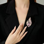 Purple flame leaf crystal brooch worn on a black blazer