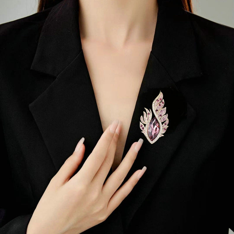 Purple flame leaf crystal brooch worn on a black blazer