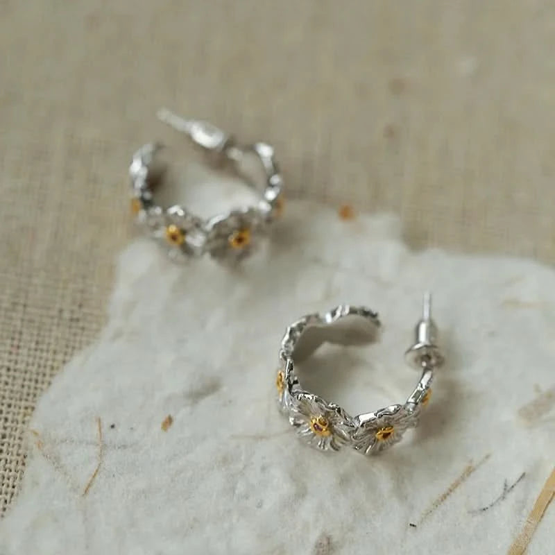 Silver hoop earrings with floral designs