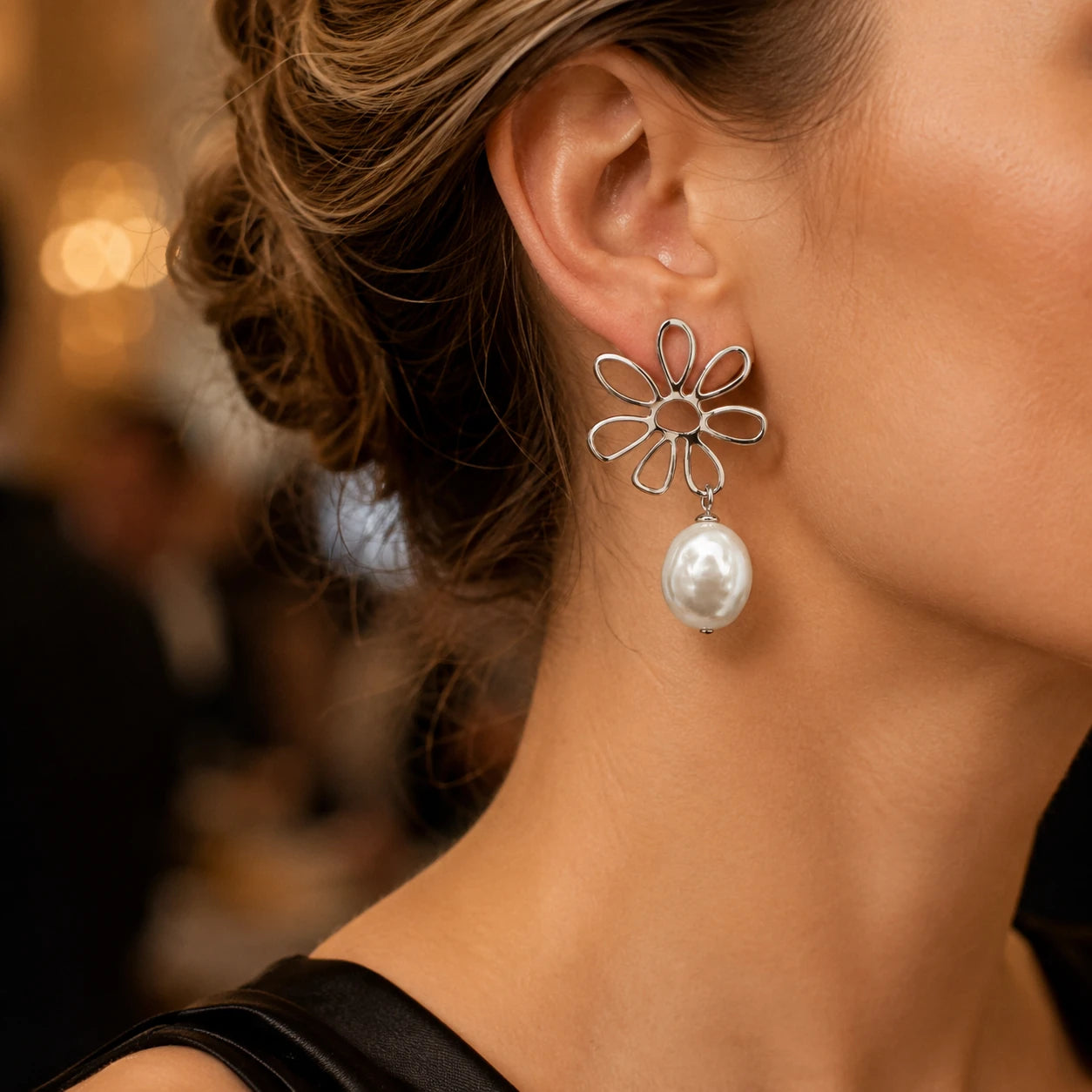 Model wearing silver flower baroque pearl drop earrings