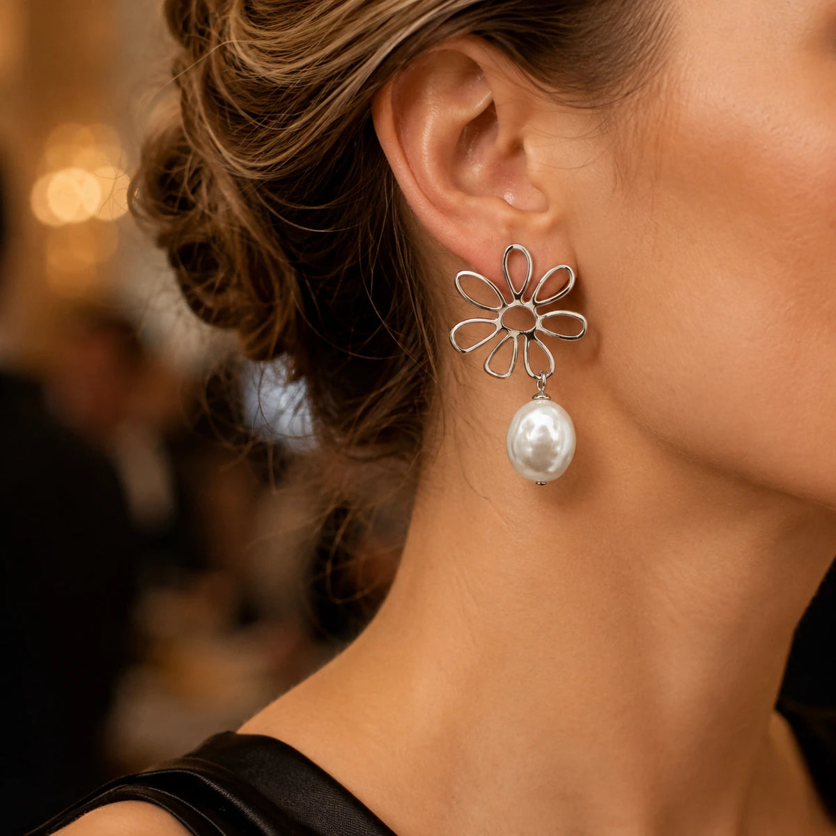 Model wearing silver flower baroque pearl drop earrings