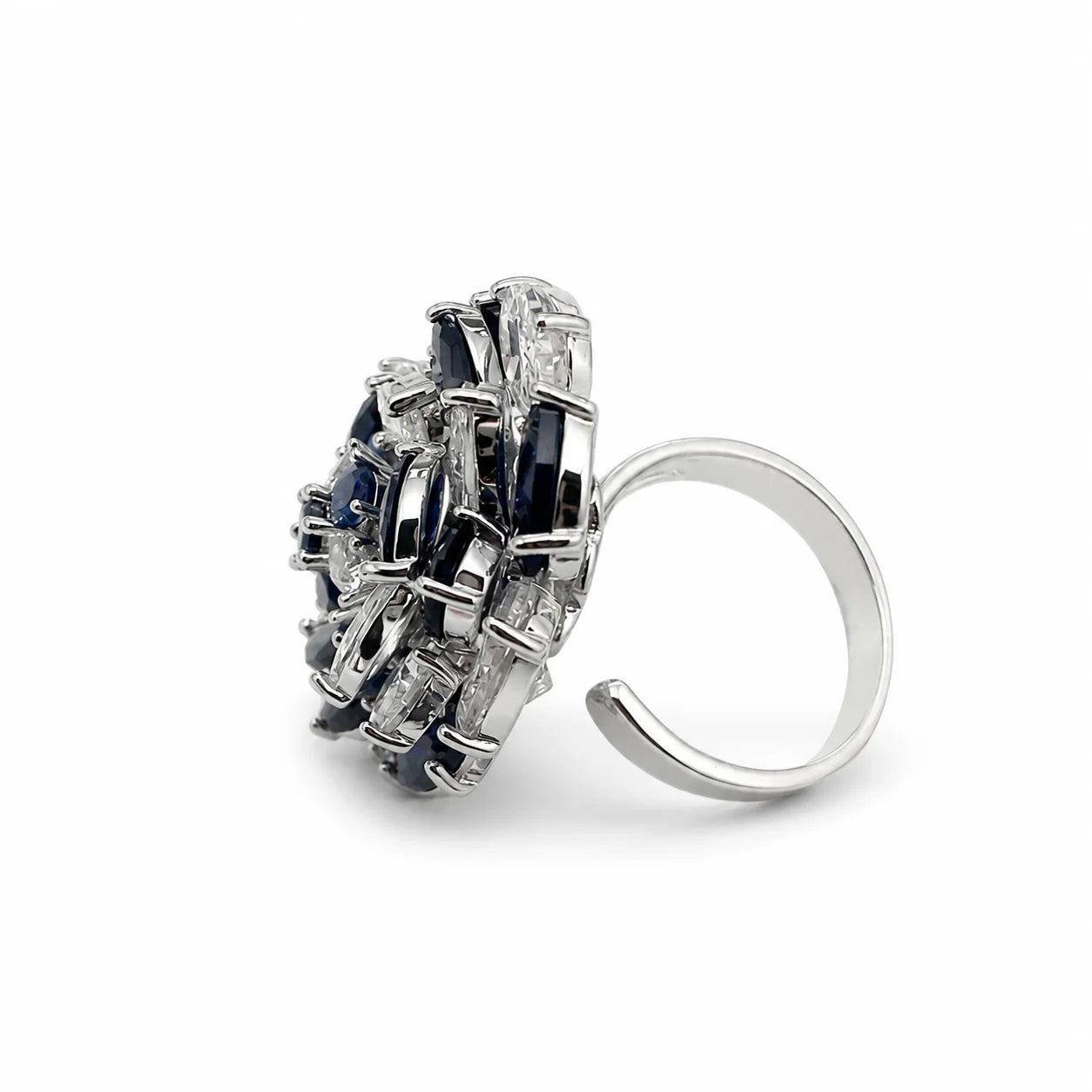 Side view of raised blue and clear zirconia flower ring with adjustable open band