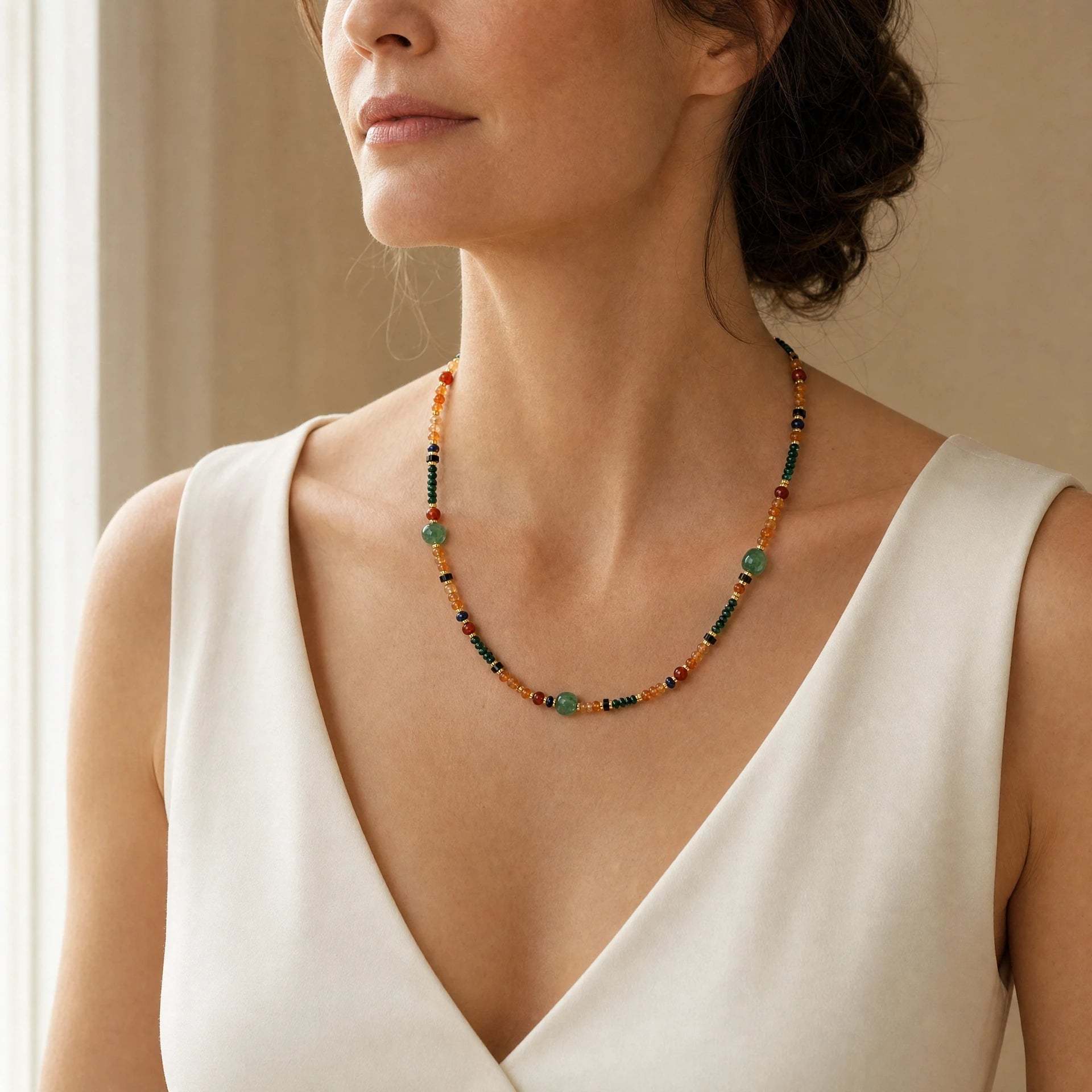 Mixed natural gemstone necklace with aventurine worn at a three quarter angle