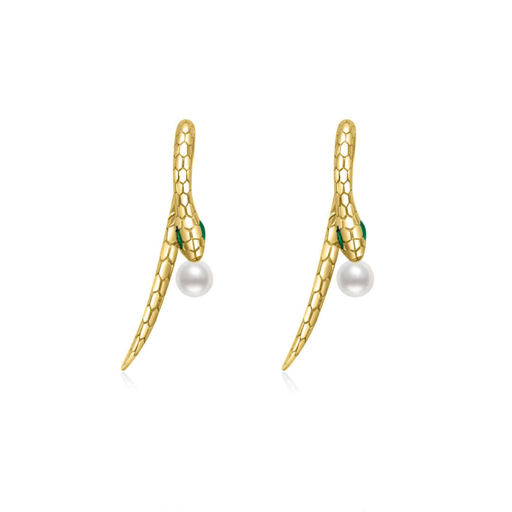 A pair of gold snake earrings with a sleek, textured scale design, featuring green crystal eyes and a single white pearl suspended at the bottom of each earring. The design is modern and minimalist, with a smooth, curved silhouette that mimics the shape of a snake in motion.