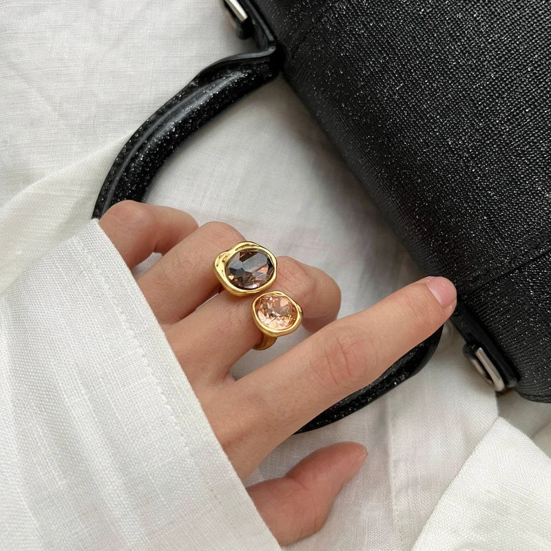 Close-up of smoky brown and champagne zirconia in irregular gold-plated settings