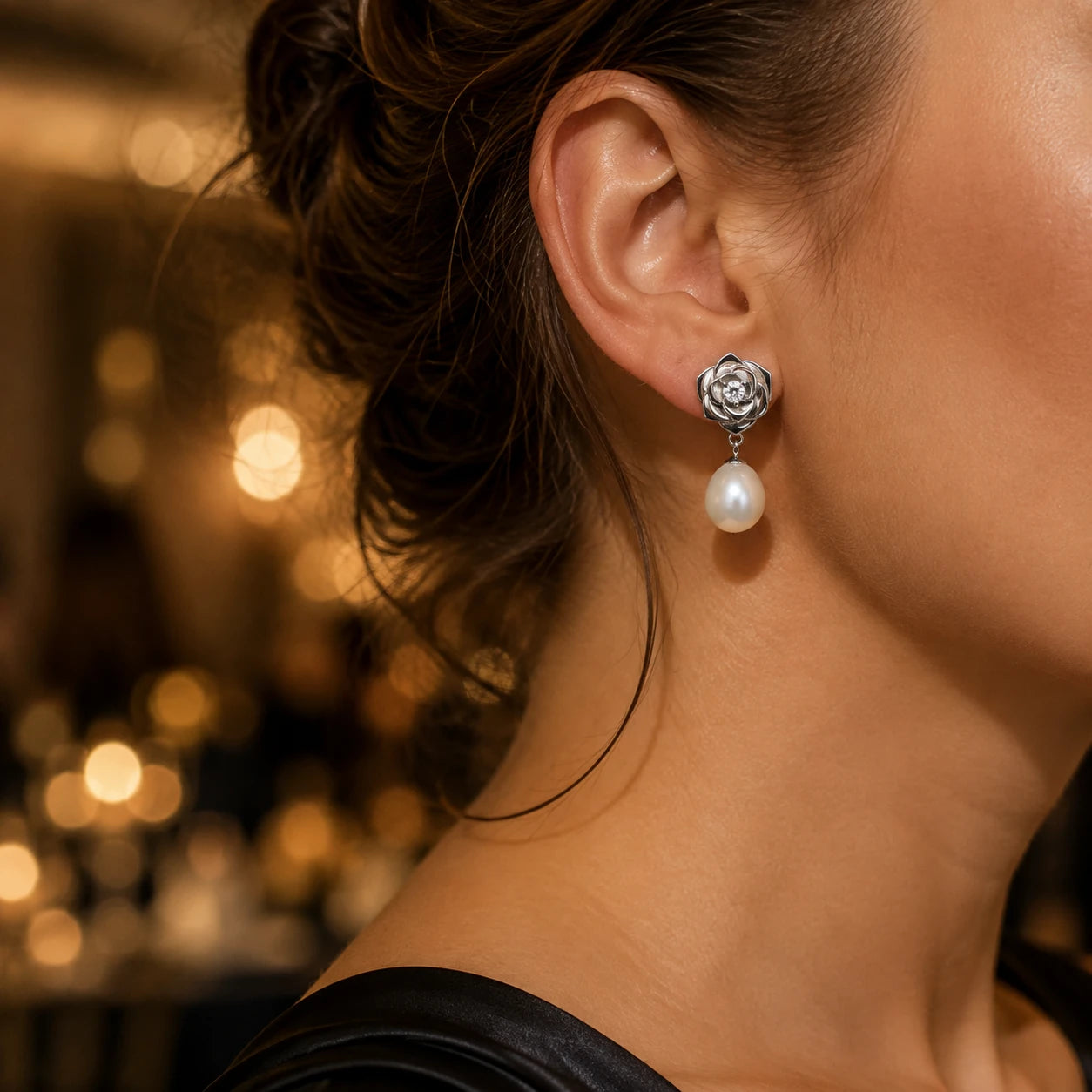 Model wearing sterling silver rose pearl drop earrings