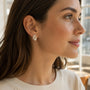 Model wearing gold-tone freshwater pearl crystal laurel stud earrings
