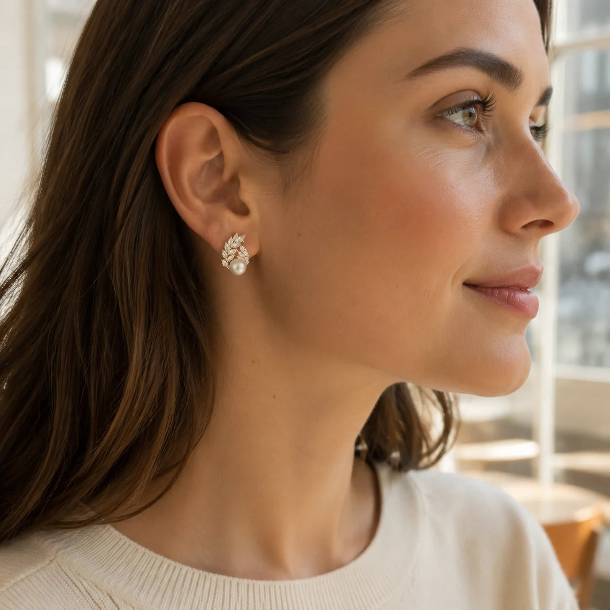 Model wearing gold-tone freshwater pearl crystal laurel stud earrings