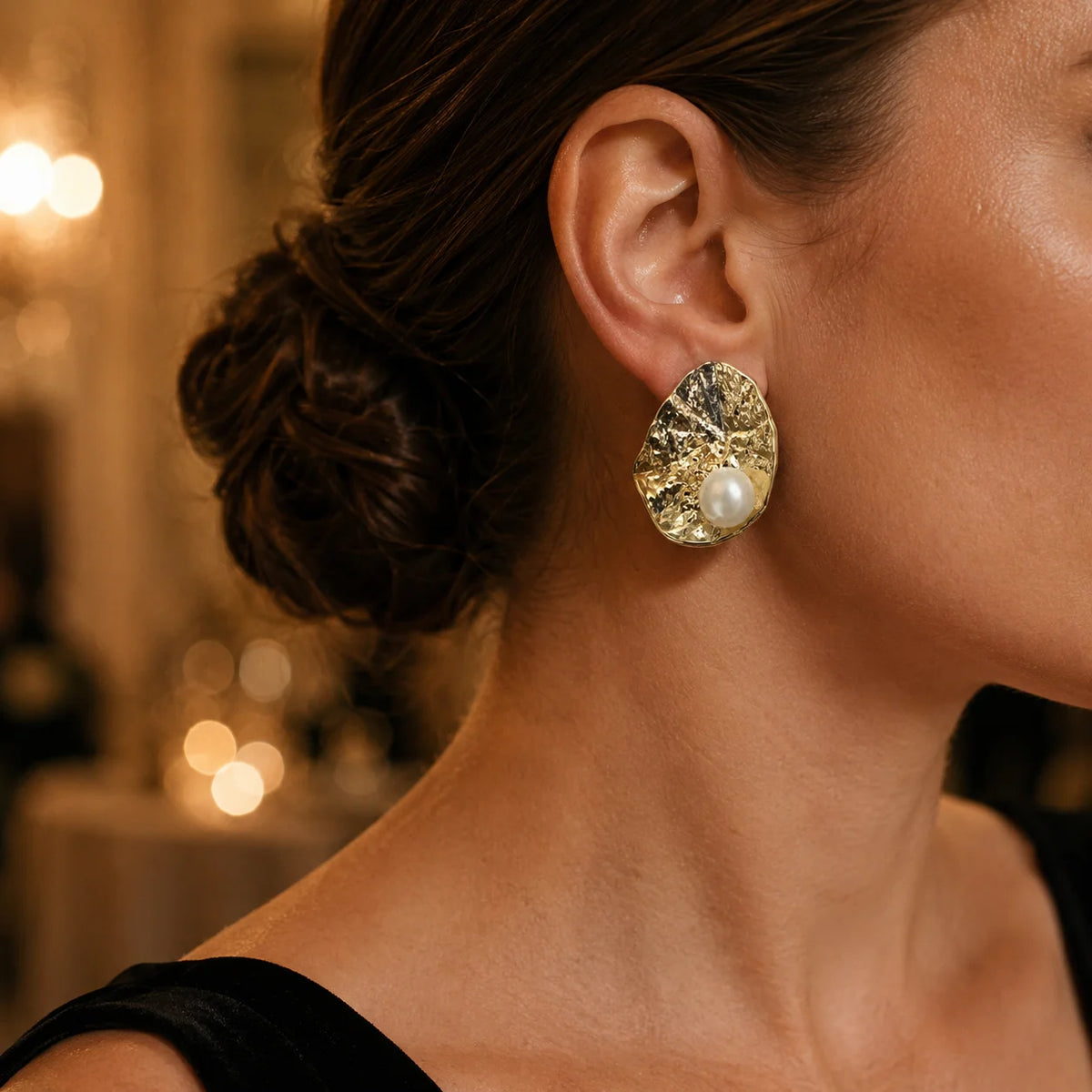 Model wearing gold-tone hammered freshwater pearl statement stud earrings