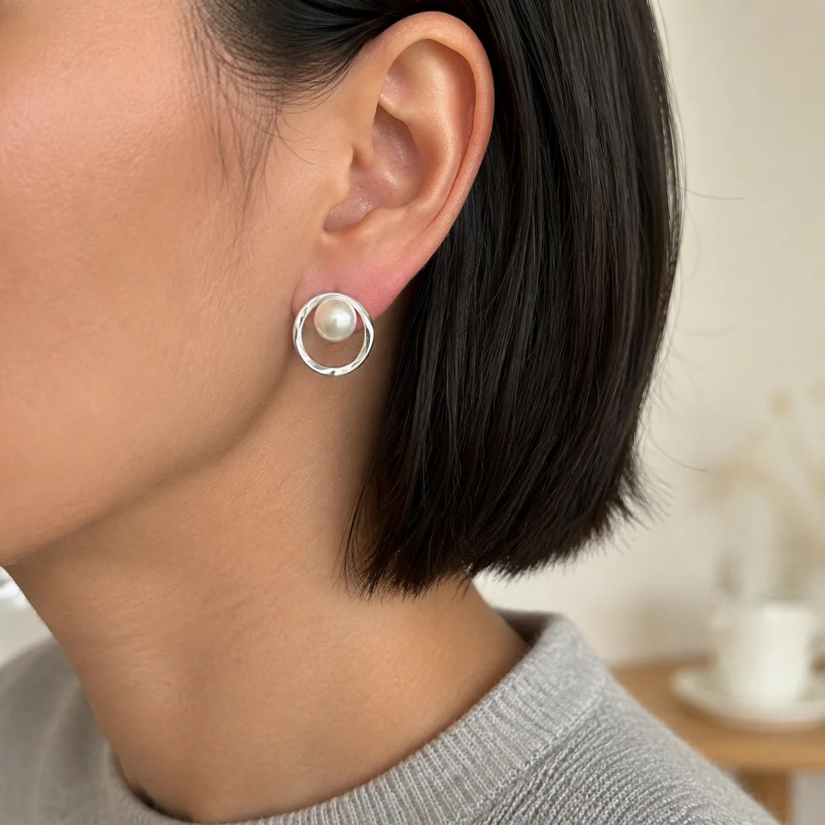 Model wearing silver-tone organic circle freshwater pearl stud earrings