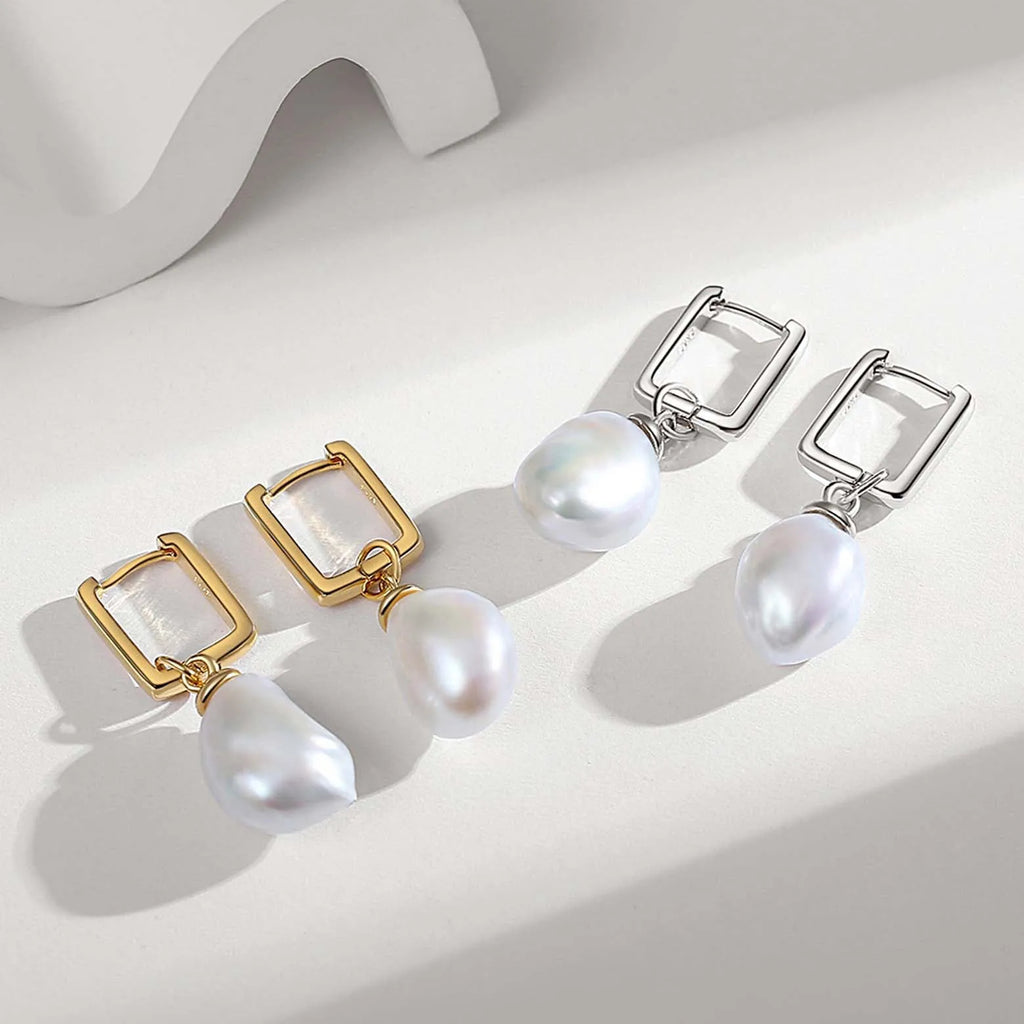  The image features two pairs of stylish earrings, each with a distinctive design. On the left, there are gold-tone earrings with a rectangular, translucent stone set in a golden frame, from which a white baroque pearl dangles, adding an organic contrast to the geometric lines of the setting. On the right, there are silver-tone earrings with a similar design: a clear rectangular stone set within a silver frame, complemented by an elegant white baroque pearl drop. 