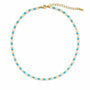 Moonstone and turquoise beaded necklace with gold-tone spacers on a white background