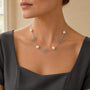 Model wearing silver-tone daisy and pearl necklace