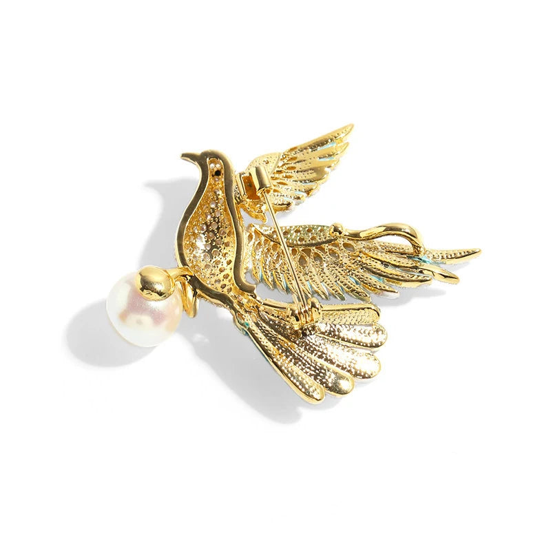 Back view of teal crystal peace dove brooch showing secure pin fastening and gold-plated copper setting