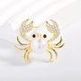 Gold-tone pearl crab brooch with cubic zirconia claws and black eyes, product detail