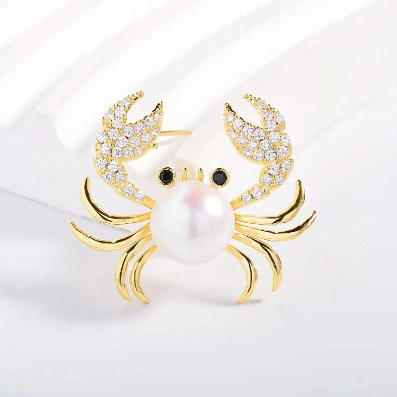 Gold-tone pearl crab brooch with cubic zirconia claws and black eyes, product detail