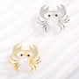 Gold-tone and silver-tone pearl crab brooch colour options with cubic zirconia claws