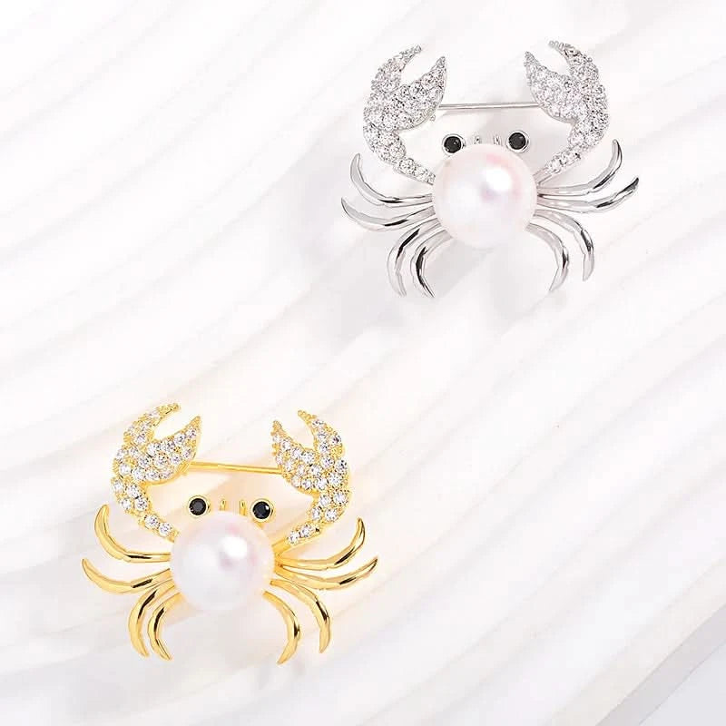 Gold-tone and silver-tone pearl crab brooch colour options with cubic zirconia claws