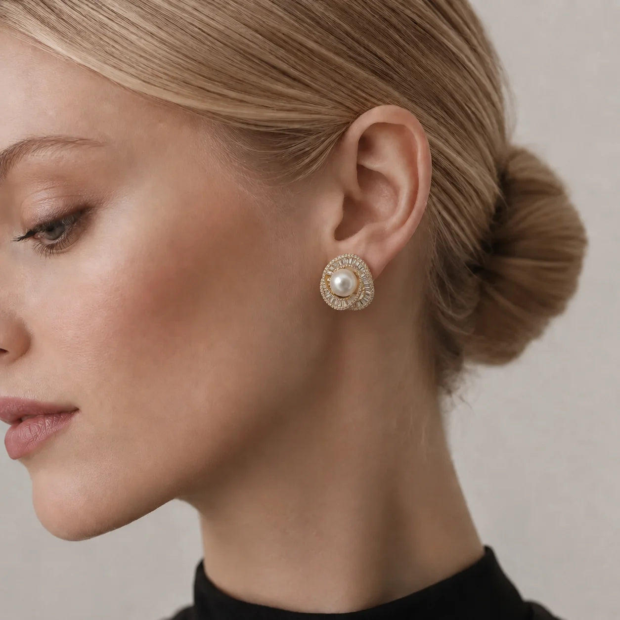 Silver-tone freshwater pearl swirl stud earrings with pavé and baguette crystals