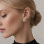 Silver-tone freshwater pearl swirl stud earrings with pavé and baguette crystals
