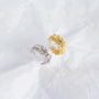 Gold and silver open rings on a white fabric background