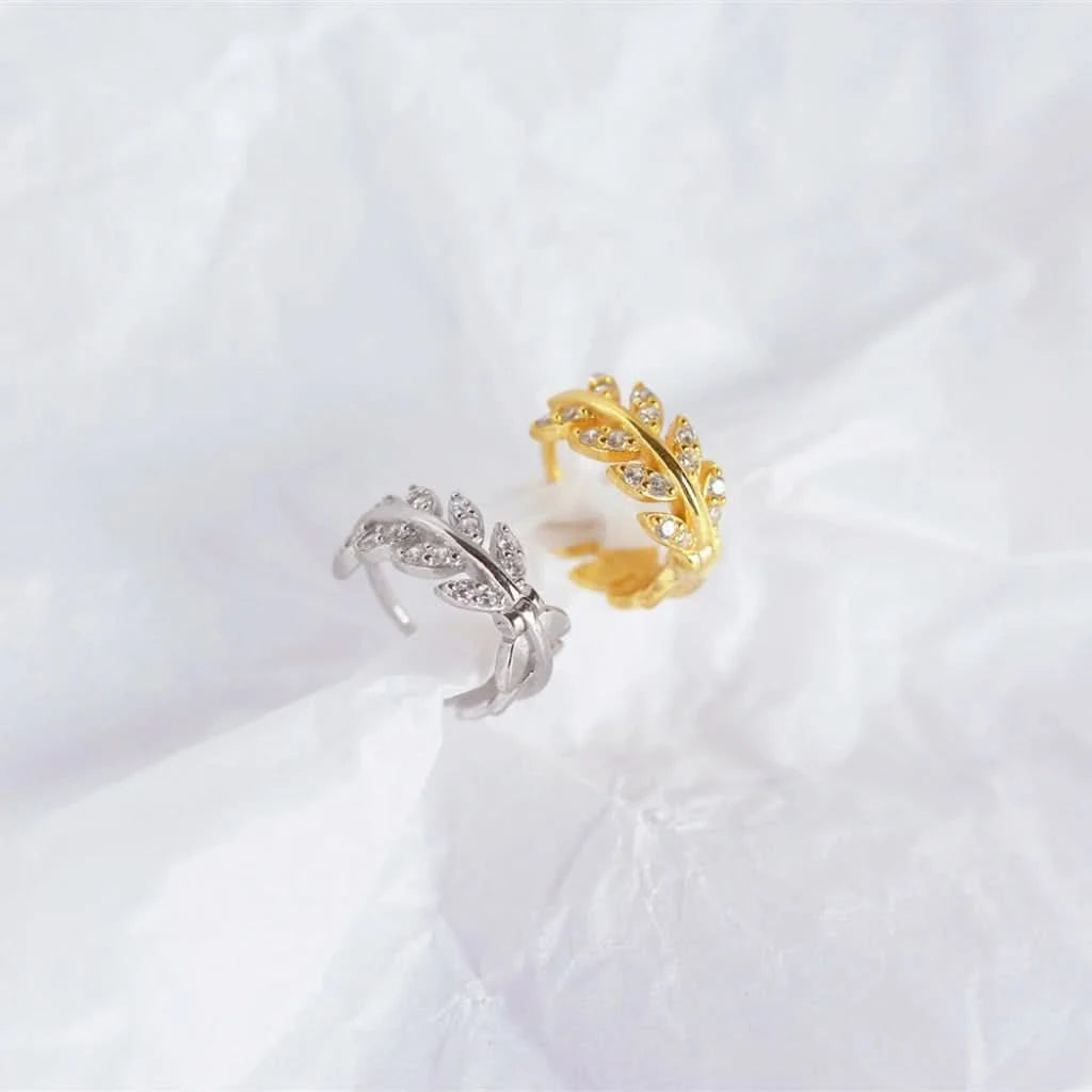 Gold and silver open rings on a white fabric background