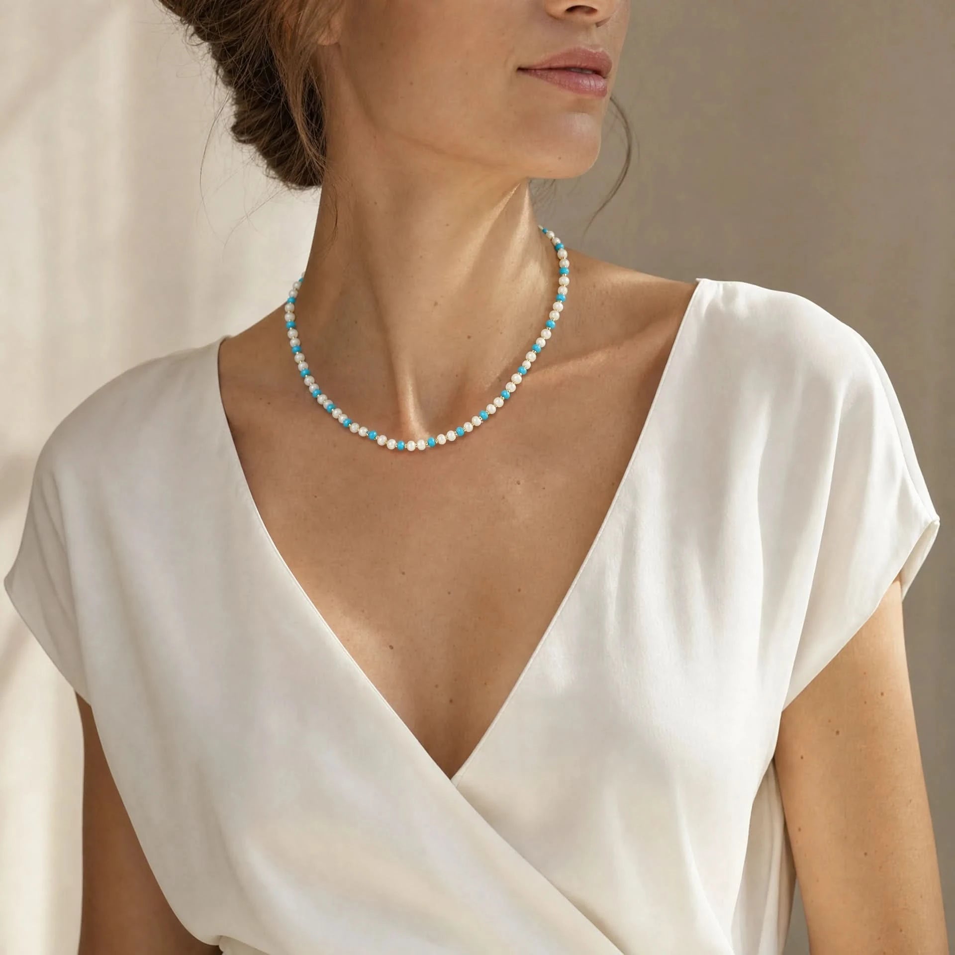 Moonstone and turquoise beaded necklace worn at a three quarter angle