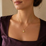 Model wearing gold-tone scallop shell pearl pendant necklace